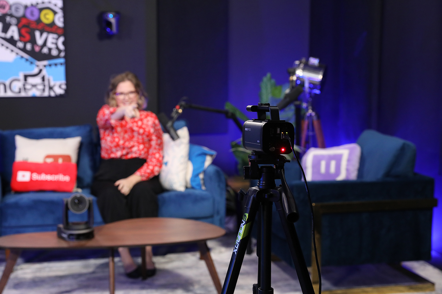 Person on couch using IR remote to control Studio Pro