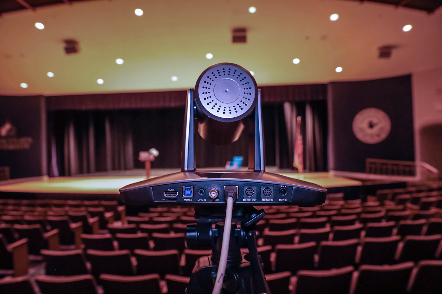 Back view of PTZOptics SimplTrack3 camera pointed at stage